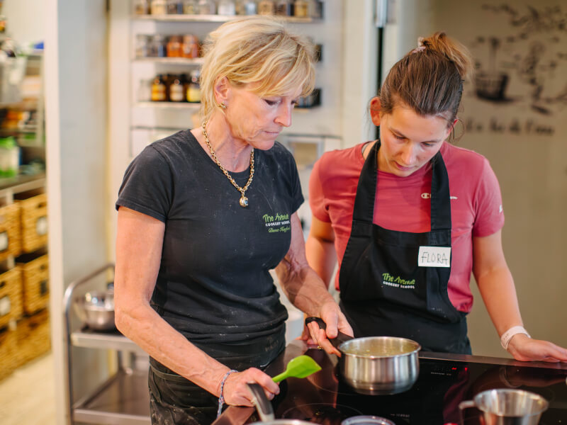 A teacher and student at a cooking class